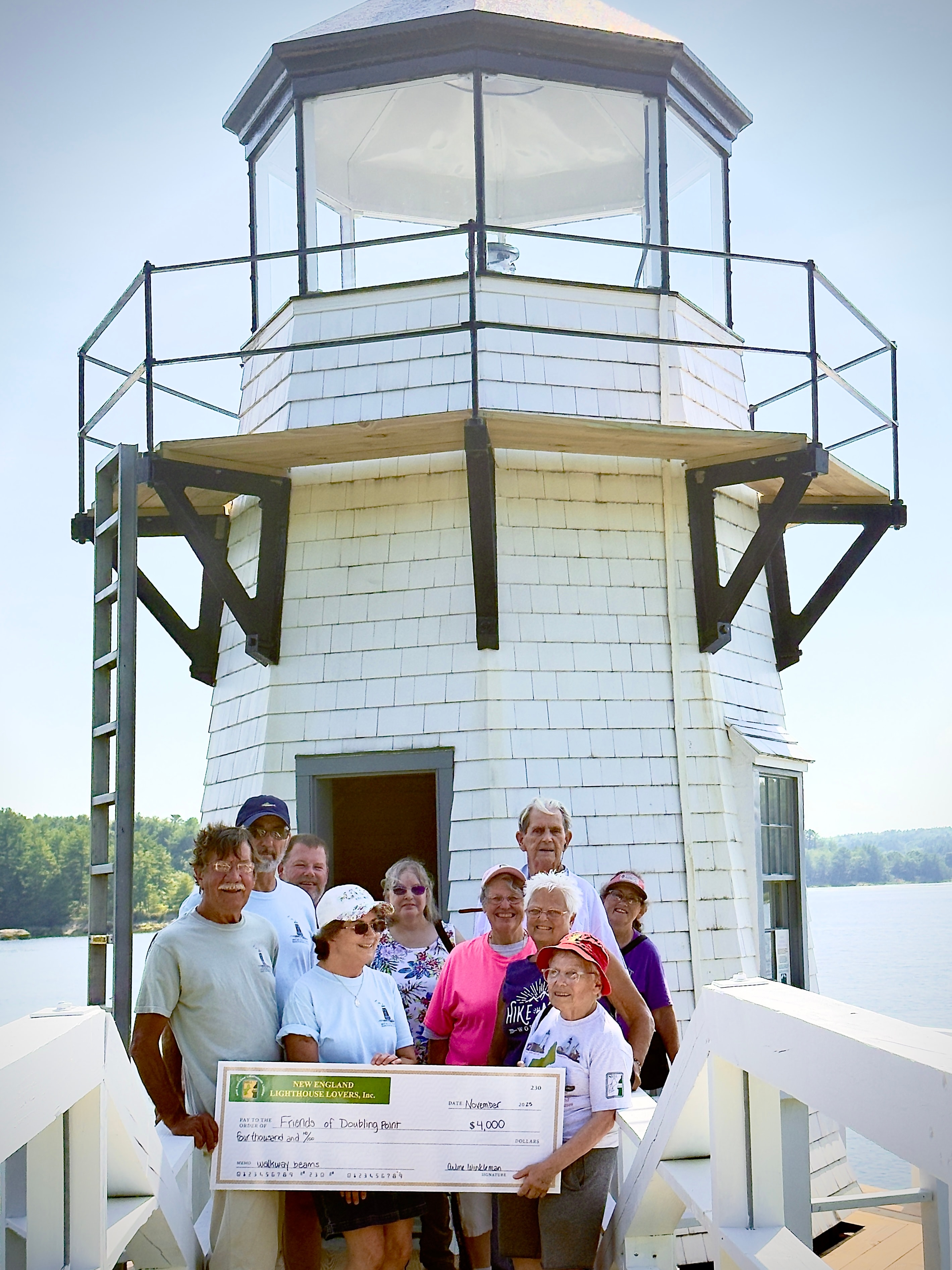 NELL members presenting $4,000 check to Friends of Doubling Point Light