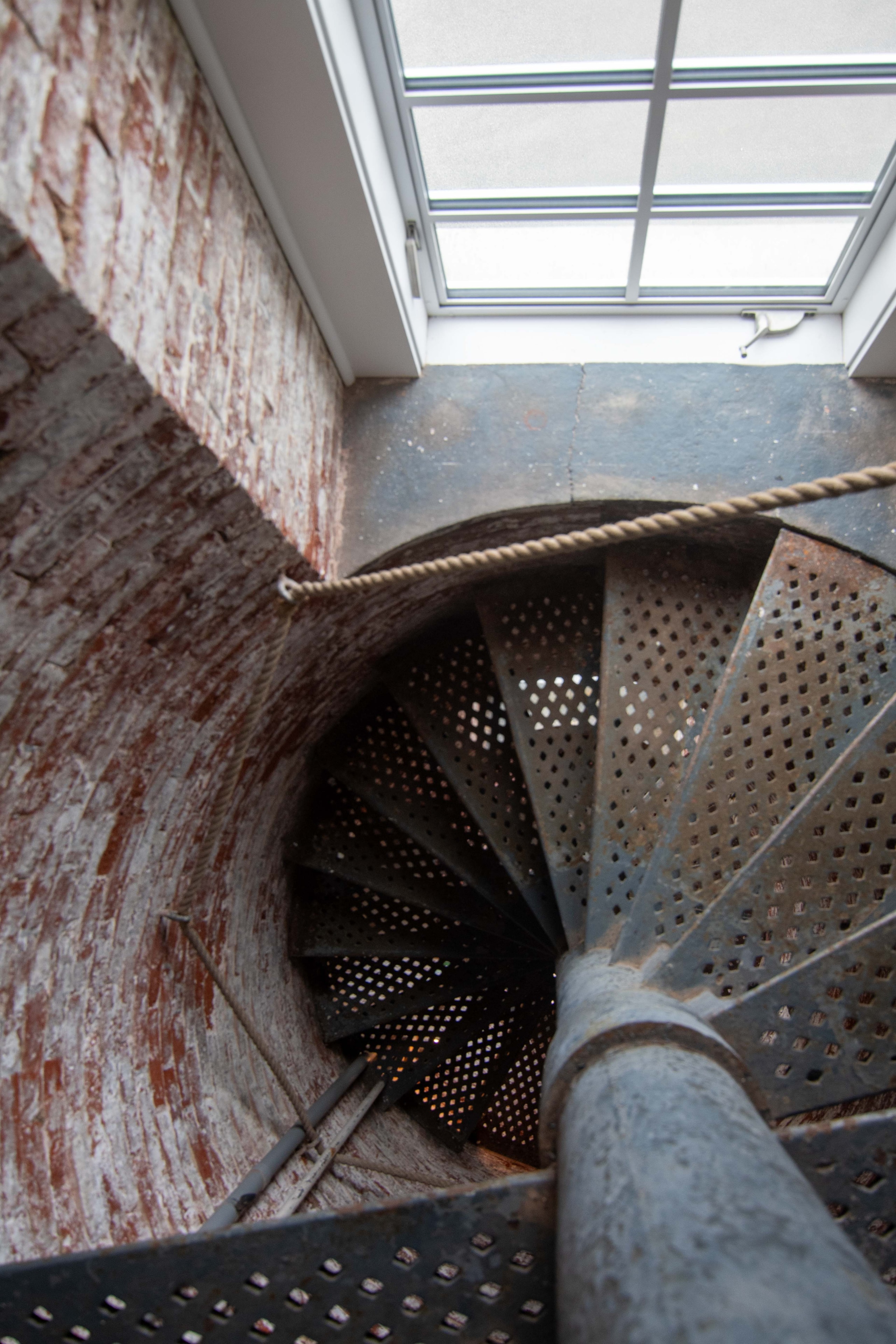 Looking down the spiral staircase inside Beavertail lighthouse tower, May 2024
